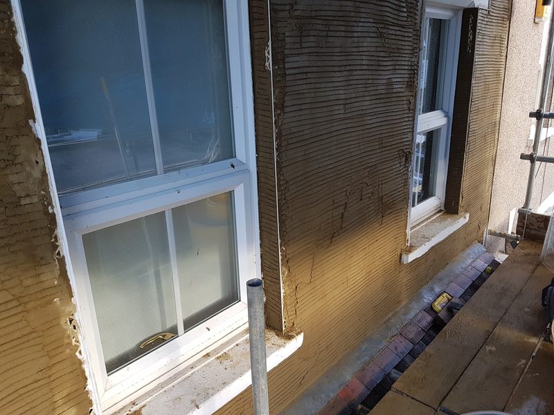 House front scratch-coated around new windows by CT2 Plastering & Rendering, Orpington